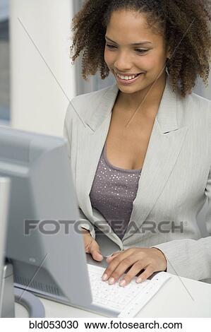 African businesswoman typing on computer View Large Photo Image Stock Image - African businesswoman typing on computer. Fotosearch