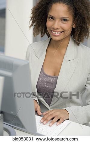 African businesswoman typing on computer View Large Photo Image Stock Image - African businesswoman typing on computer. Fotosearch