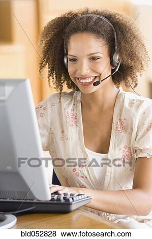 Stock Photo - African businesswoman wearing headset. Fotosearch