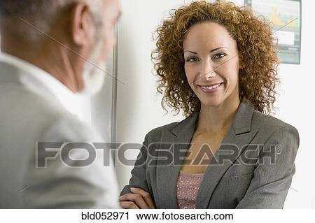 Stock Image - African businesswoman with arms crossed. Fotosearch