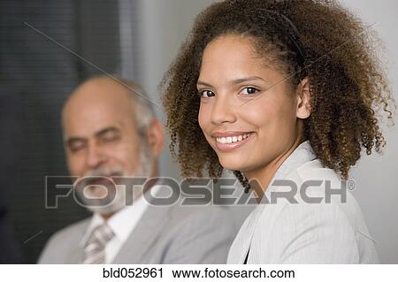Stock Image - African businesswoman with curly hair. Fotosearch