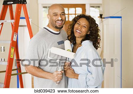 African couple being silly with paint rollers View Large Photo Image Stock Image - African couple being silly with paint rollers. Fotosearch