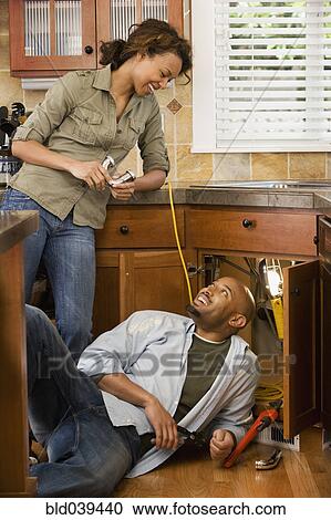 African couple installing kitchen sink View Large Photo Image Stock Image - African couple installing kitchen sink. Fotosearch