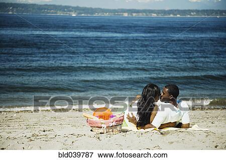 Stock Photo - African couple kissing on beach. Fotosearch