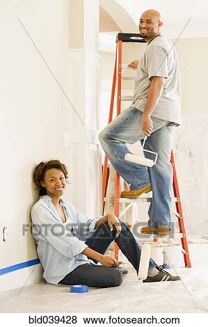 Stock Photo - African couple painting indoors. Fotosearch