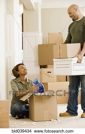 African couple unpacking in new house View Large Photo Image Picture - African couple unpacking in new house. Fotosearch