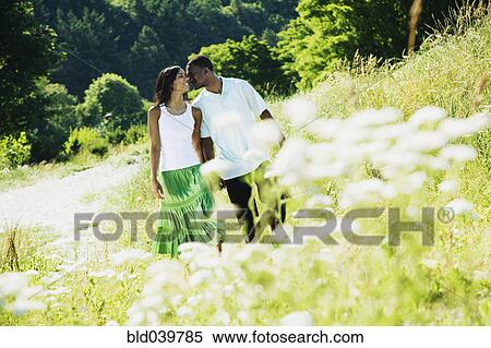 Stock Photography - African couple walking in park. Fotosearch