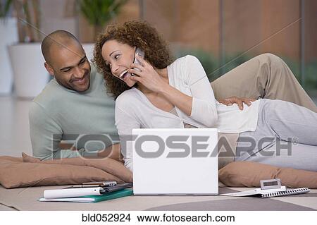 Picture - African couple working on floor. Fotosearch