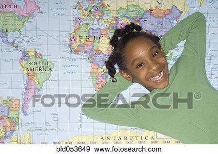 African girl laying on world map View Large Photo Image Stock Photo - African girl laying on world map. Fotosearch