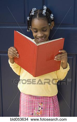 Picture - African girl reading book. Fotosearch