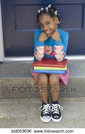 African girl sitting with school books View Large Photo Image Stock Photograph - African girl sitting with school books. Fotosearch