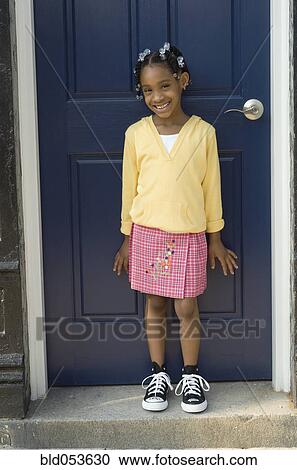 African girl standing in front of door View Large Photo Image Stock Image - African girl standing in front of door. Fotosearch