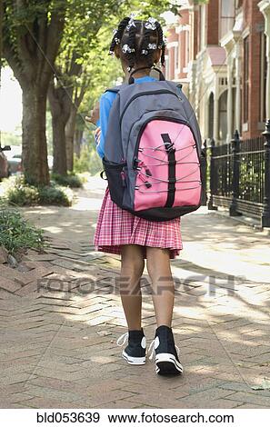 Stock Photo - African girl wearing backpack. Fotosearch