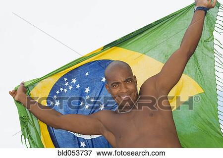 African man holding up beach wrap View Large Photo Image Stock Photo - African man holding up beach wrap. Fotosearch