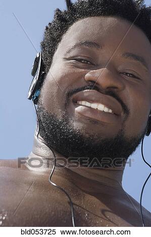 African man listening to headphones View Large Photo Image Stock Photography - African man listening to headphones. Fotosearch