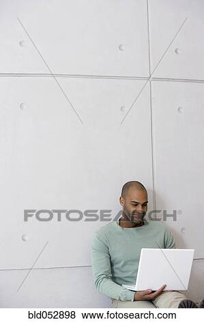 African man looking at laptop View Large Photo Image Stock Photo - African man looking at laptop. Fotosearch