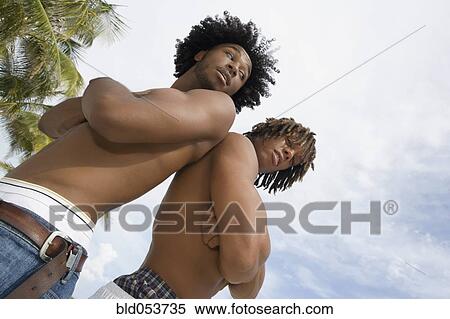 African men standing back to back View Large Photo Image Stock Photography - African men standing back to back. Fotosearch