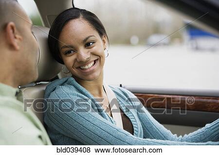 Stock Photo - African teenager in car with father. Fotosearch