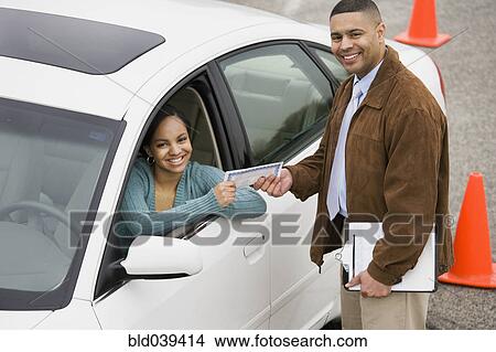 African teenager receiving drivers test certificate View Large Photo Image Picture - African teenager receiving drivers test certificate. Fotosearch