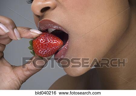African woman eating strawberry View Large Photo Image Stock Photograph - African woman eating strawberry. Fotosearch