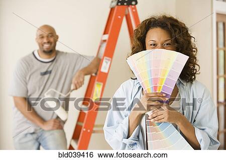 African woman holding paint swatches View Large Photo Image Stock Photograph - African woman holding paint swatches. Fotosearch