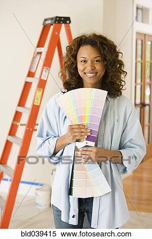 African woman holding paint swatches View Large Photo Image Stock Photography - African woman holding paint swatches. Fotosearch