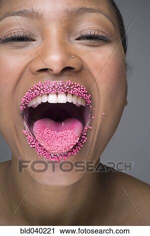 African woman laughing with sprinkles on lips View Large Photo Image Stock Image - African woman laughing with sprinkles on lips. Fotosearch