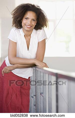 African woman leaning on railing View Large Photo Image Stock Photo - African woman leaning on railing. Fotosearch