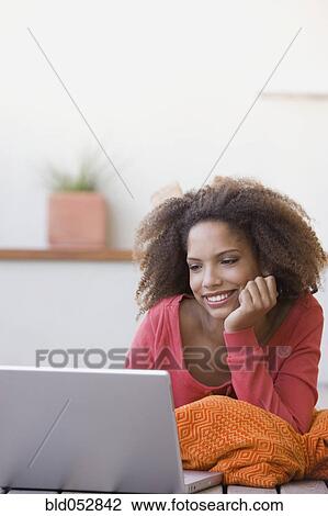 African woman looking at laptop View Large Photo Image Stock Image - African woman looking at laptop. Fotosearch