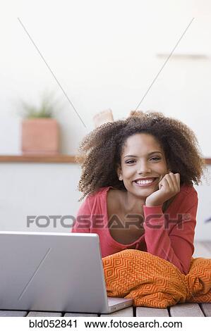 African woman next to laptop View Large Photo Image Stock Image - African woman next to laptop. Fotosearch