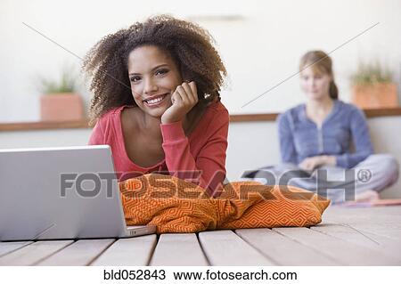 African woman next to laptop View Large Photo Image Stock Image - African woman next to laptop. Fotosearch