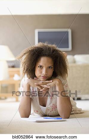 African woman on floor with note pad View Large Photo Image Picture - African woman on floor with note pad. Fotosearch