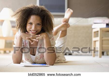African woman on floor with note pad View Large Photo Image Stock Photography - African woman on floor with note pad. Fotosearch
