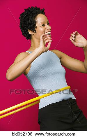 African woman playing with hula hoop View Large Photo Image Stock Photograph - African woman playing with hula hoop. Fotosearch