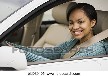 Stock Photography - African woman sitting in car. Fotosearch