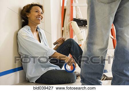 African woman taking break from painting View Large Photo Image Stock Photo - African woman taking break from painting. Fotosearch