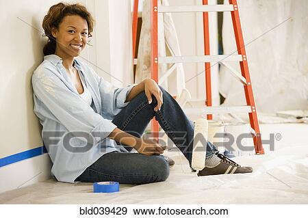 African woman taking break from painting View Large Photo Image Stock Photo - African woman taking break from painting. Fotosearch