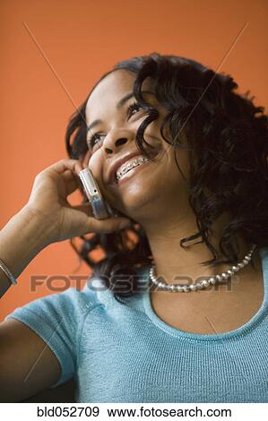 African woman talking on cell phone View Large Photo Image Stock Photo - African woman talking on cell phone. Fotosearch