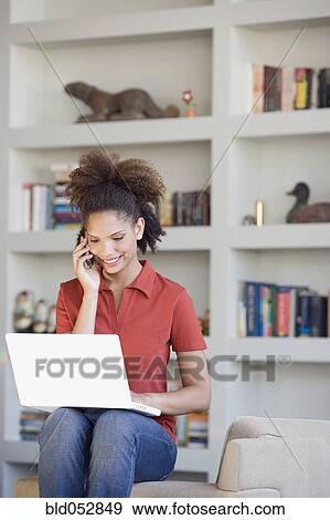 Stock Photo - African woman talking on cell phone. Fotosearch