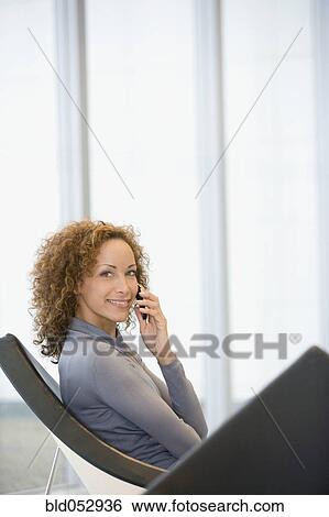 Stock Photograph - African woman talking on cell phone. Fotosearch