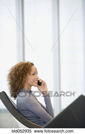 Stock Photography - African woman talking on cell phone. Fotosearch