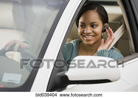 African woman using hands free device in car View Large Photo Image Picture - African woman using hands free device in car. Fotosearch
