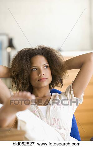 African woman with feet up on desk View Large Photo Image Stock Photo - African woman with feet up on desk. Fotosearch