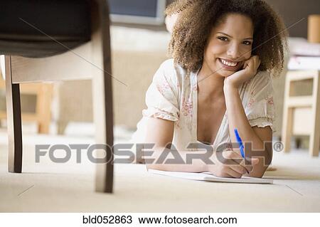 African woman writing on note pad View Large Photo Image Stock Image - African woman writing on note pad. Fotosearch