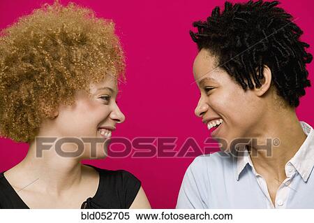 Stock Photography - African women smiling at each other. Fotosearch