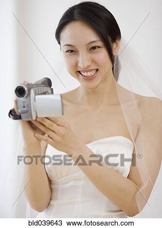 Asian bride using video camera View Large Photo Image Stock Image - Asian bride using video camera. Fotosearch