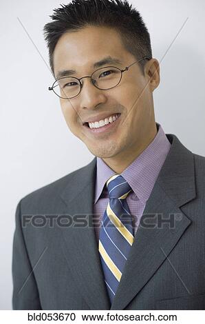 Asian businessman wearing eyeglasses View Large Photo Image Stock Image - Asian businessman wearing eyeglasses. Fotosearch