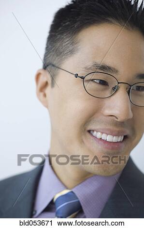 Stock Image - Asian businessman wearing eyeglasses. Fotosearch