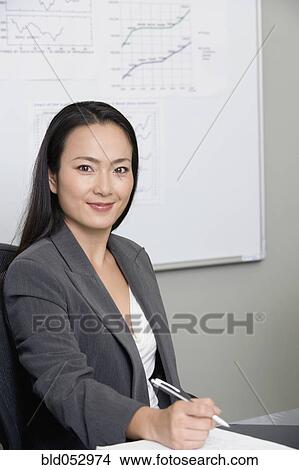 Asian businesswoman holding pen View Large Photo Image Picture - Asian businesswoman holding pen. Fotosearch