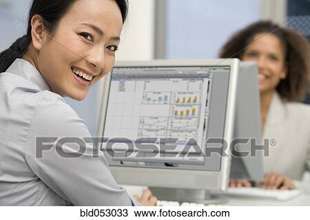 Asian businesswoman typing on computer View Large Photo Image Stock Image - Asian businesswoman typing on computer. Fotosearch